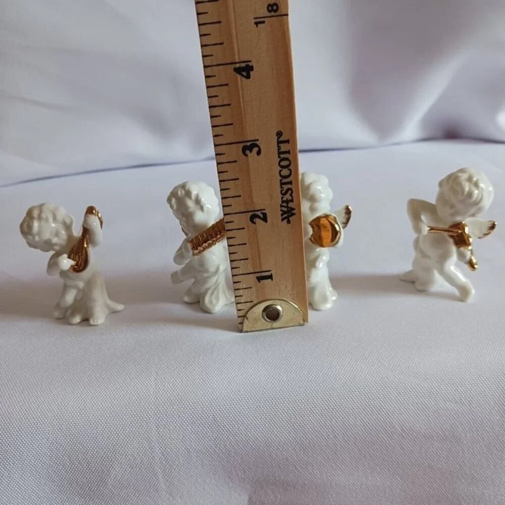 Bone china set of 4 angels gathered playing instruments